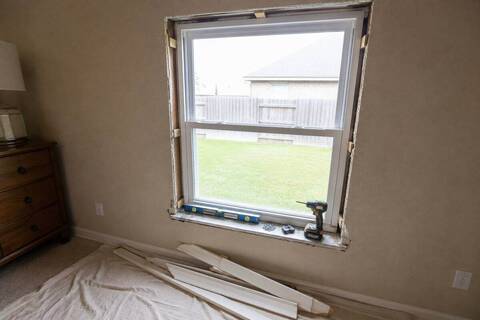 Window set in a framed opening and shimmed